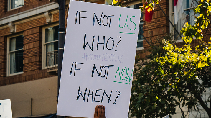 "If not us, who? If not now, when?" sign