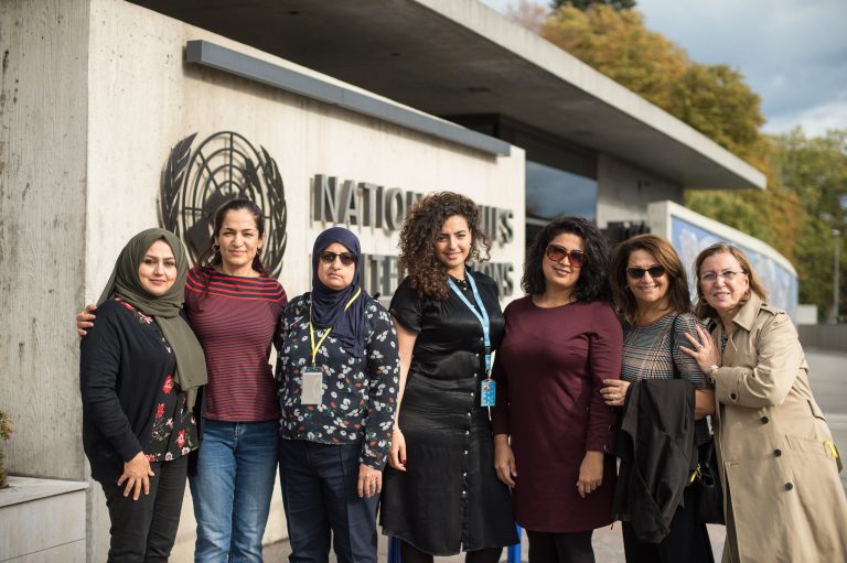 Group photo of Iraqi delegation at the CEDAW, seven women and girls standing in front of UN building
