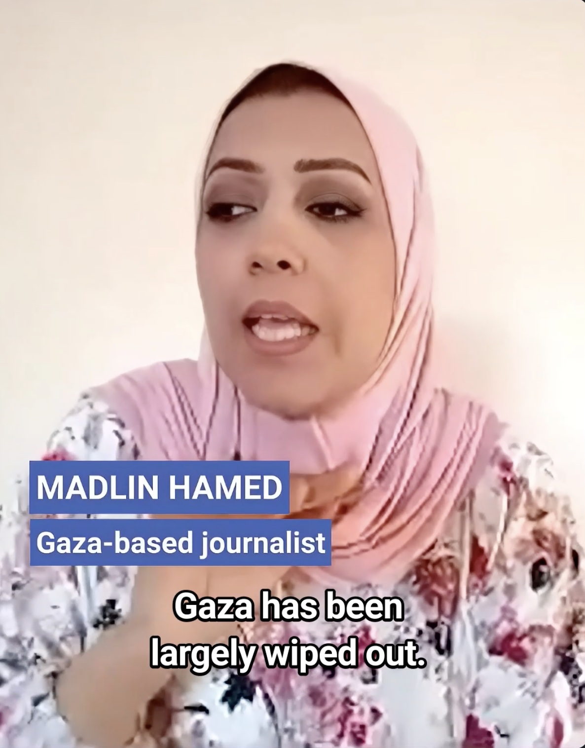 A woman in a light pink hijab and floral top speaks. On-screen text reads: MADLIN HAMED, Gaza-based journalist. Caption below says: Gaza has been largely wiped out.